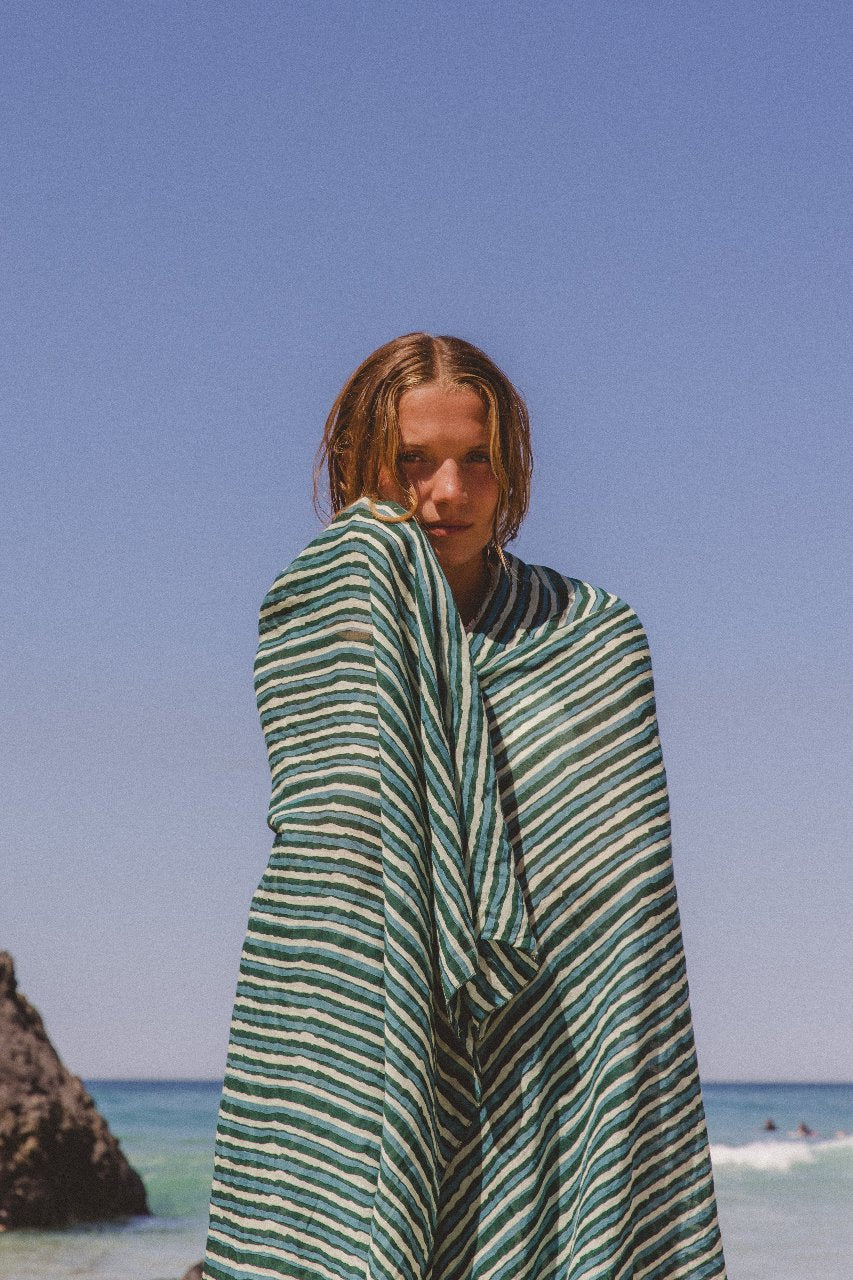 Ria Sarong Cyan Candy — model in movement, flowing cyan sarong wrap in motion, block print cotton showing drape, effortless resort style artisan India | Daughters of India