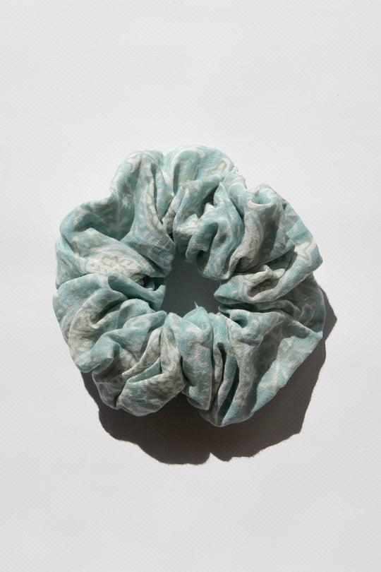 Daughters of India Upcycled Scrunchie in Sea Mist, a light blue-green hair scrunchie made from upcycled cotton fabric with subtle print