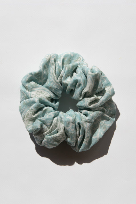 Daughters of India Upcycled Scrunchie in Sea Mist, a light blue-green hair scrunchie made from upcycled cotton fabric with subtle print